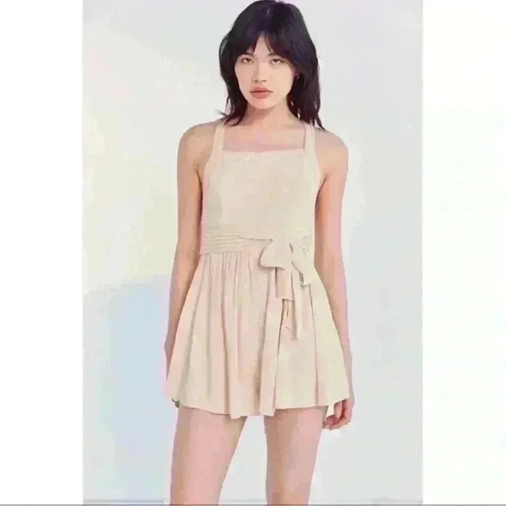 NWT Tan romper with a criss crossed open back
